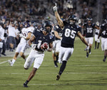 UCF’s Mike Hughes returns a punt 66 yards for a touchdown against East Carolina. Stephen M. Dowell / Orlando Sentinel