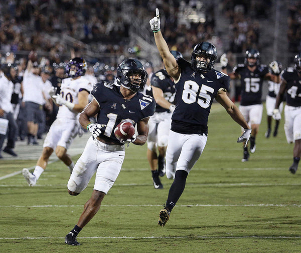 UCF’s Mike Hughes returns a punt 66 yards for a touchdown against East Carolina. Stephen M. Dowell / Orlando Sentinel