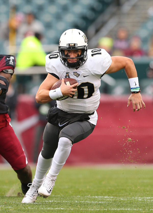 UCF QB McKenzie Milton runs for some yardage against Temple. Milton had six carries for 23 yards and a touchdown. AP Photo / Rich Schultz