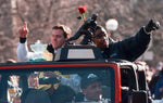 Brian Griese, with the Rose Bowl mvp trophy, and Charles Woodson, with the Heisman, ride in a Jeep and wave to the crowds gathered on State st. during the celebration parade for the University of Michigan football team Sunday afternoon in Ann Arbor. David P. Gilkey / Detroit Free Press