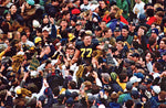 Jon Jensen (77) gets lifted by the crowd after their 20-14 win over  OSU on Nov. 22, at Michigan Stadium. Michigan's win  earned them a trip to the Rose Bowl and the Big Ten Championship. Kirthom F. Dozier / Detroit Free Press
