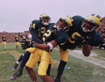 Michigan Cornerback (2) Charles Woodson, center, gets congratulated by teammates (24) Patrick McCall, left, and (9) Diallo Johnson  after Woodson’s  second-quarter punt return for a Touchdown against OSU on Nov. 22 at Michigan Stadium. Michigan went on to beat  OSU 20-14 and earn a trip to the Rose Bowl and the Big Ten Championship. David P. Gilkey / Detroit Free Press