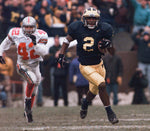 Michigan Cornerback (2) CHARLES WOODSON, races away from OSU's (24) SCOTT FULTON  during WOODSON's 2nd Quarter punt return for a Touchdown against OSU on Nov. 22, at Michigan Stadium. Michigan went on to beat  OSU 20-14 and earn a trip to the Rose Bowl and the Big Ten Championship. David P. Gilkey / Detroit Free Press