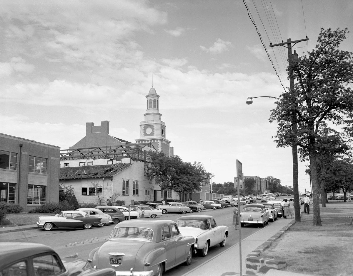 Cars parked along Chestnut Street, with a view of the North Texas State College Administration Building under construction, 1956. Courtesy University Photograph Collection (U0458), University of North Texas Special Collections / #UNTA_U0458-090-009-02