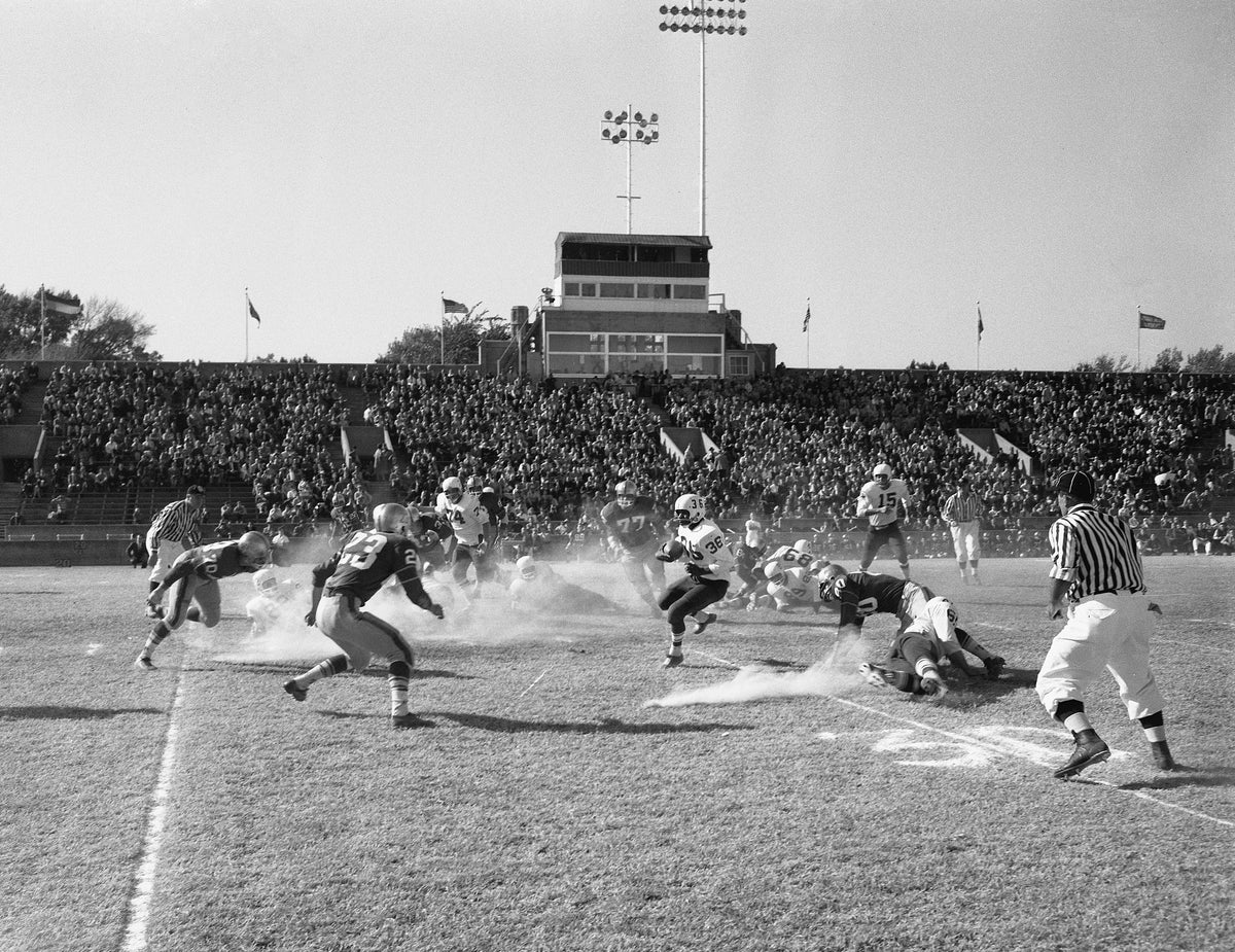 Players kicking up sand during a football game between North Texas State College and University of Tulsa, 1960. Courtesy University Photograph Collection (U0458), University of North Texas Special Collections / #UNTA_U0458-094-346-02
