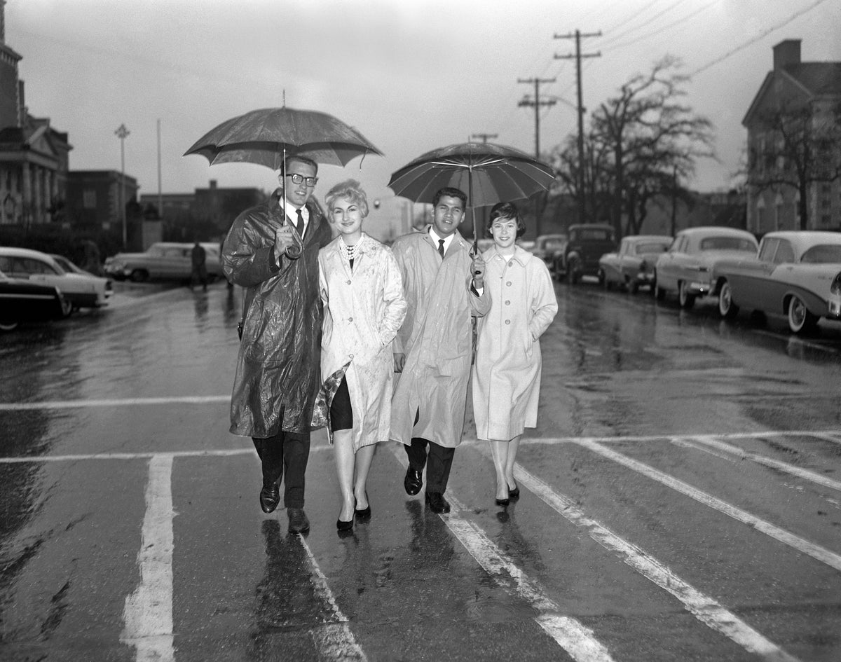 Junior class student officers at North Texas State University walking along the street in Denton, 1961. From left: Art Hull, vice president; Sandra Hamilton, secretary; Henry Castillo, president; Carolyn Cass, treasurer. Courtesy University Photograph Collection (U0458), University of North Texas Special Collections / #UNTA_U0458-096-539-02