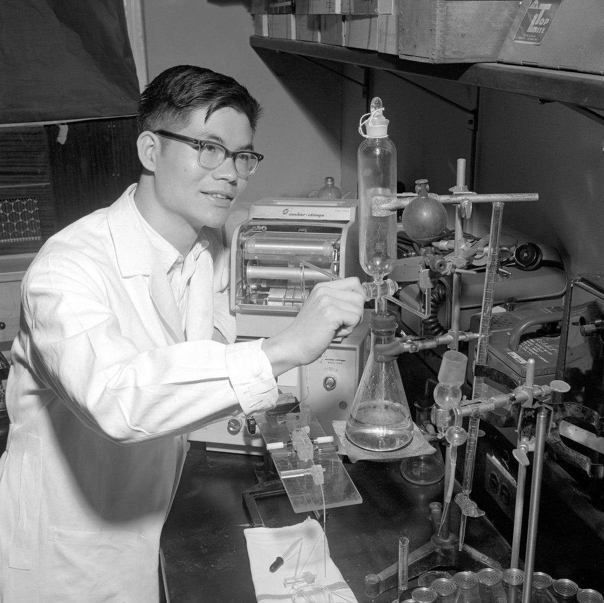 Chui Hsu Yang, a North Texas State University student from Taiwan, working on a biology experiment in 1961. He is releasing a liquid from a buret into an Erlenmeyer flask. Courtesy University Photograph Collection (U0458), University of North Texas Special Collections / #UNTA_U0458-106-625-07