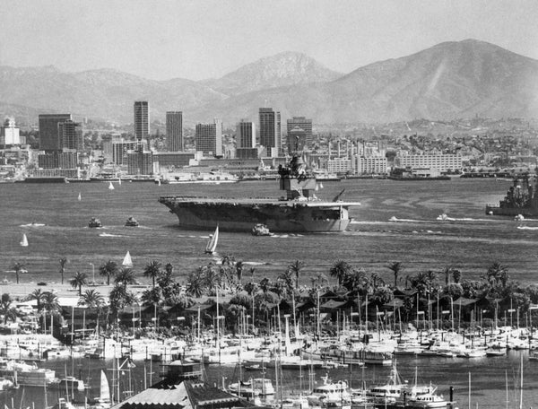 The 90,00-ton nuclear-powered aircraft carrier USS Enterprise moves through San Diego Bay on its way to North Island Naval Air Station in March 1971. Photographer Joe Holly caught the scene from Point Loma on a clear day that took in downtown high rises and the mountains in the distance. Union-Tribune, photo by Joe Holly