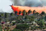 A CDF airplane drops fire retardant on a fire burring near Fairbanks Ranch, May 13, 2014. K.C. Alfred / The San Diego Union-Tribune