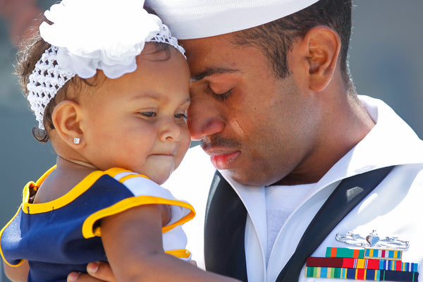 Yeoman 2nd Class Antonio Woods hugs his 11-month-old daughter, Amora, upon his arrival at San Diego Naval Base. Woods and nearly 300 other sailors returned home after a seven-month deployment in the Western Pacific aboard the guided-missile destroyer Howard, one of 18 that call San Diego home. The Arleigh Burke-class destroyers are considered the workhorses of the fleet and are heavily stocked with a mix of missiles. K.C. Alfred / The San Diego Union-Tribune