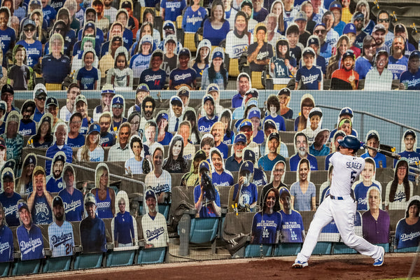 It had the feel of a Fellini movie as Corey Seager warms up in the on-deck circle in front of a bevy of cardboard cutouts at Dodger Stadium. Robert Gauthier / Los Angeles Times