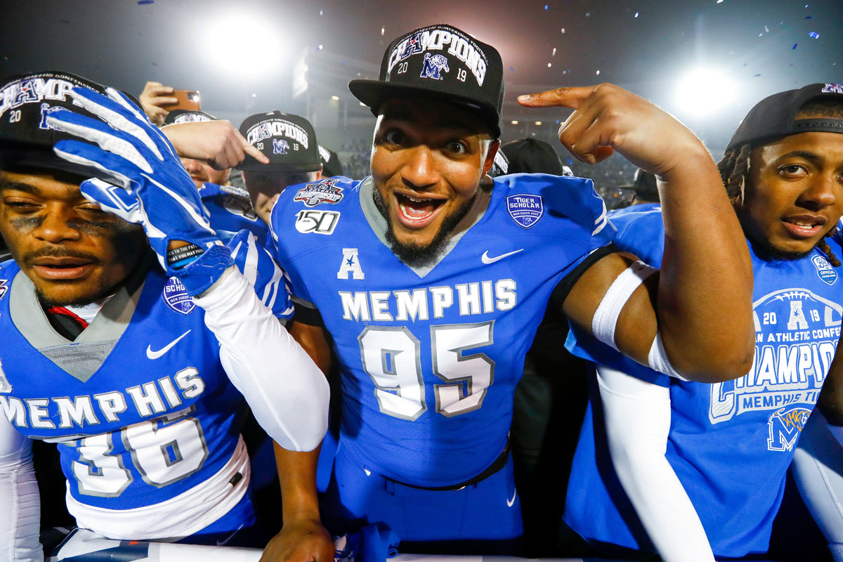 Memphis Tigers players LaDarius Jordan, from left, Keith Brigham and Markevion Quinn celebrate the second straight win over Cincinnati. Courtesy Joe Rondone / The Commercial Appeal