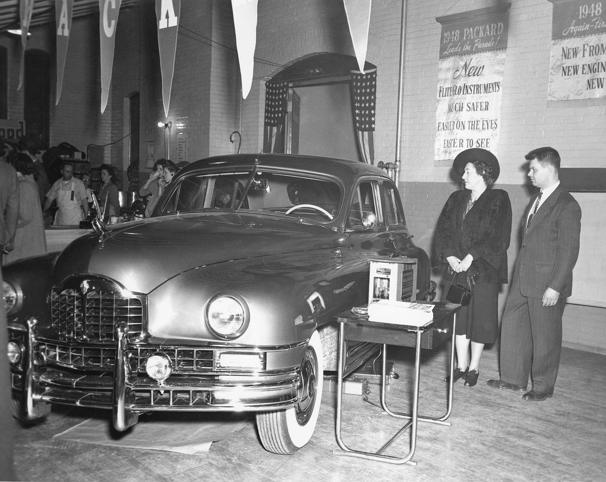Philip Delone and his mother-in-law admiring the new 1948 Packard Custom in the Bromely Packard dealership in Glens Falls, 1948. Courtesy Charles Flinchbaugh
