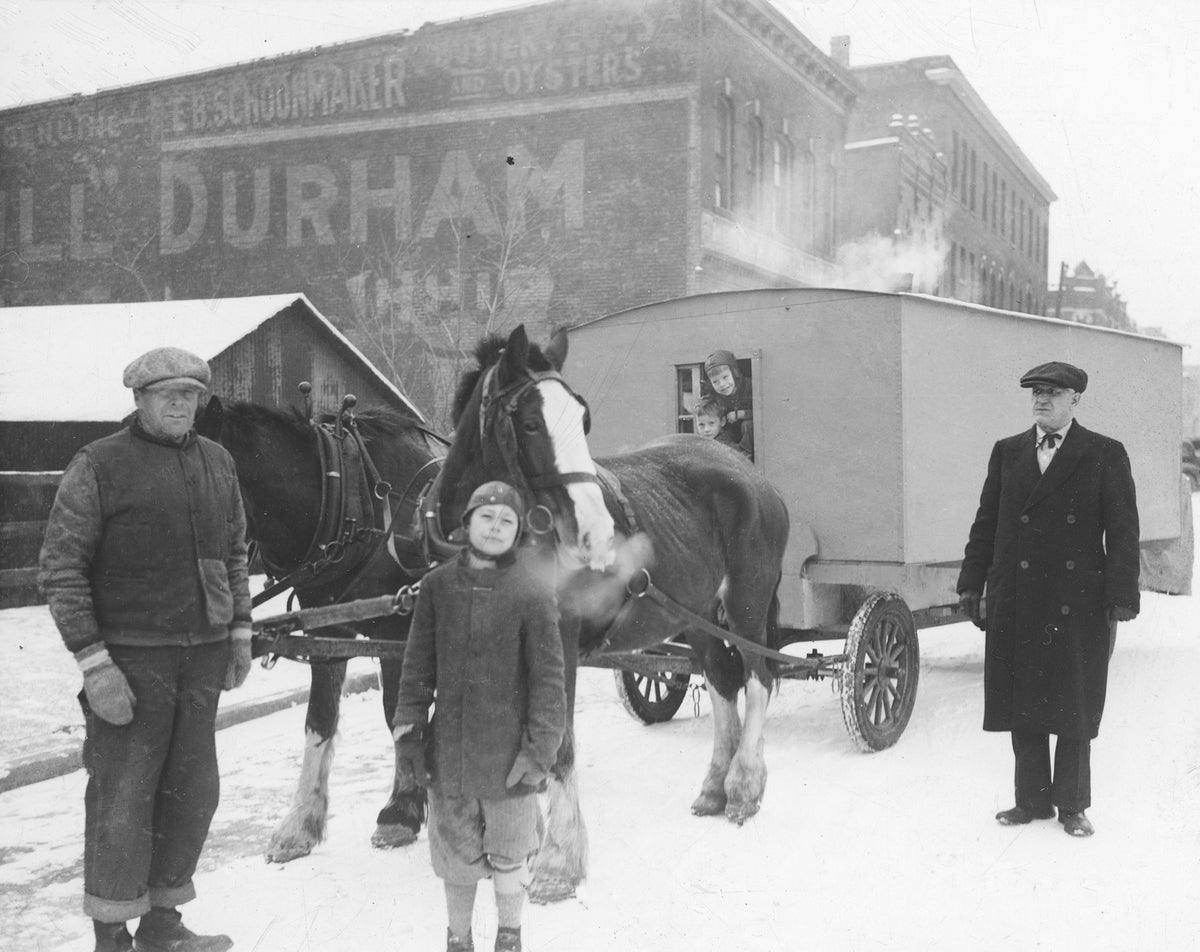 Horse-drawn mobile home on East Second Street, early 1900s. The Latsch Building is in the background. Courtesy Winona County Historical Society