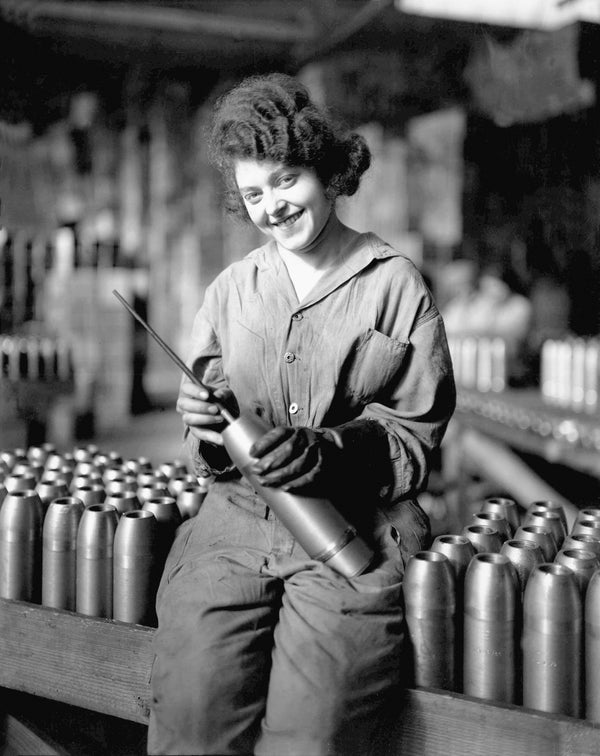 A young munitions worker at the Maxwell Motor Company holds a shell during World War I. Courtesy The Detroit News