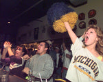 Outside the Touchdown Cafe on S. University in Ann Arbor,  U of M football fans take to the streets to celebrate. Richard Lee / Detroit Free Press