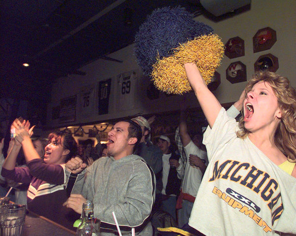 Outside the Touchdown Cafe on S. University in Ann Arbor,  U of M football fans take to the streets to celebrate. Richard Lee / Detroit Free Press