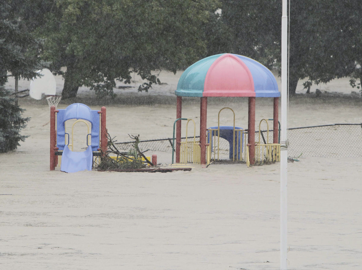 Wappasening Creek floods the playground in Kirby Park in Nichols on Wednesday afternoon. JEFF RICHARDS / STAFF PHOTO