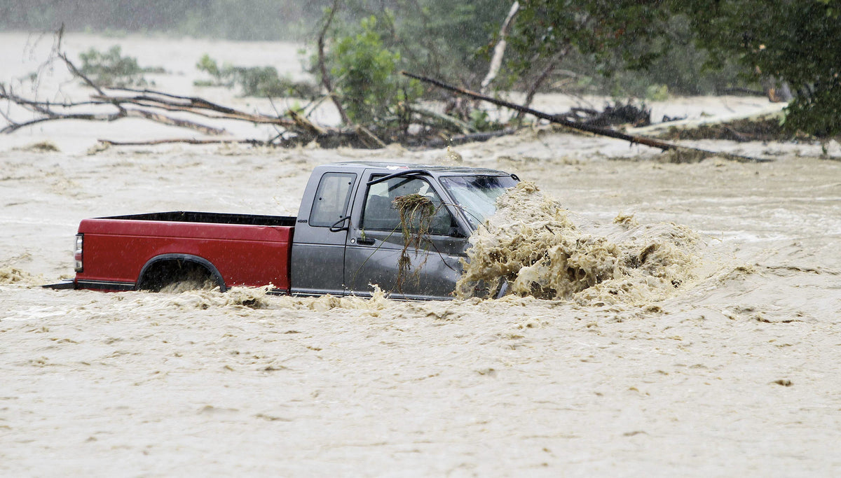 A pickup truck is stranded in the field full of water from Wappasening Creek along Route 282 south of Nichols Wednesday afternoon. JEFF RICHARDS / STAFF PHOTO