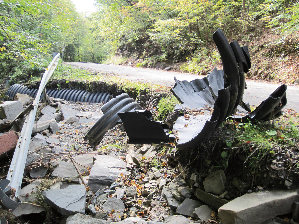 Steve Reilly / STAFF PHOTO A large portion of Pollard Hill Road in the Town of Maine was destroyed by flooding last week. Town officials said it will cost the municipality $5 to $7 million to recover from the flood.