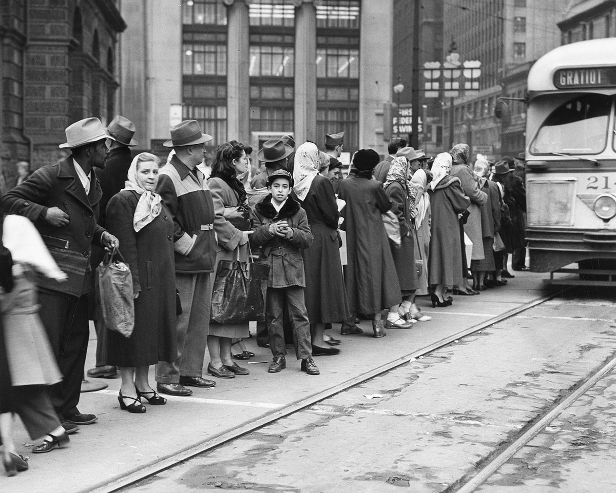 Passengers waiting in queue for streetcar No. 214 at Woodward and Michigan Avenues in the early 1950s. Courtesy Detroit Public Library ^^ center light rgba(40,40,35,0.5)