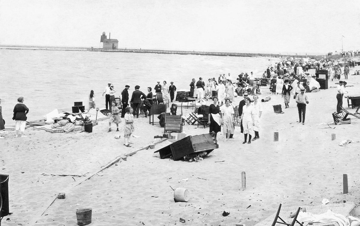 Summer residents with salvaged items from their homes and cottages scattered along the beach following a massive fire, Macatawa, July 16, 1922. Thirty cottages were destroyed by the fire. Courtesy Joint Archives of Holland