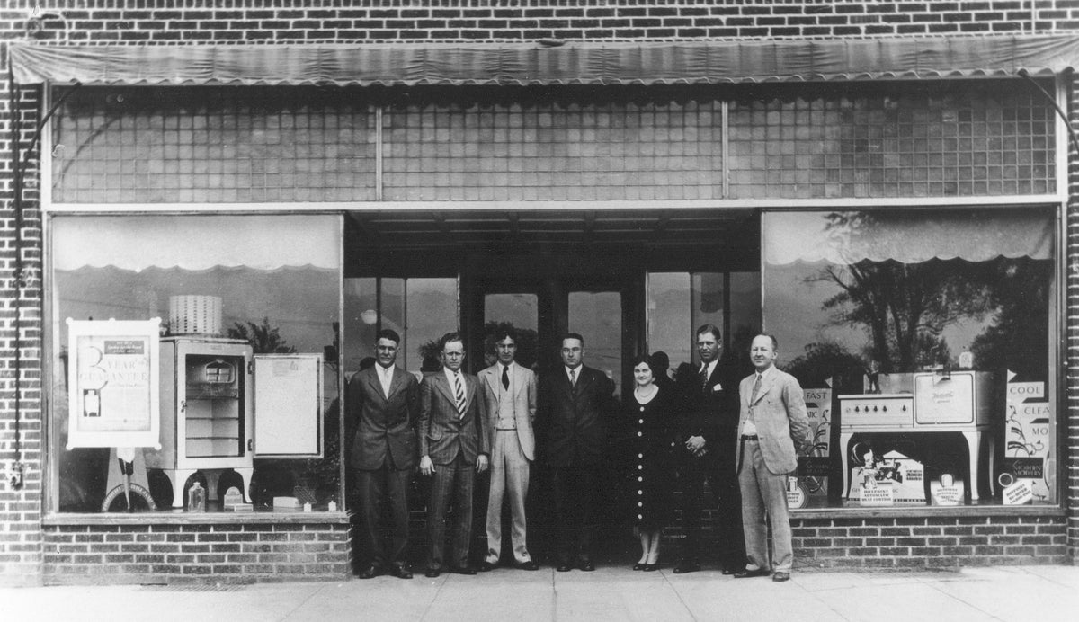 Staff of the Belton Light and Power Company in front of the company’s headquarters on the Square, 1930s. In the windows, the latest in kitchen appliances are being offered by the company. Employees, from left to right: Alvin Greer, Furman Browning, Julius Blake, Louis Steel, Miss Nell Hogg, Roscow Willingham and Julian Walton pose outside their office. Courtesy Belton Area Museum Association