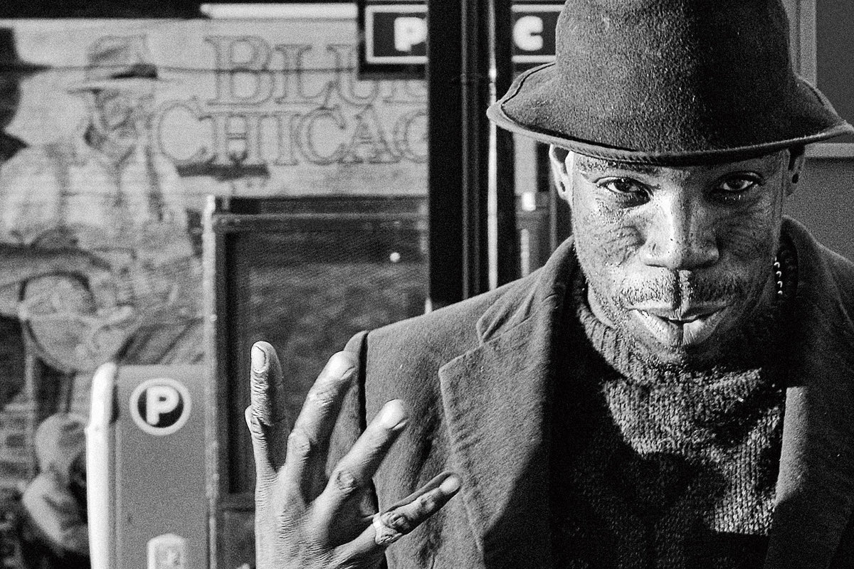I was photographing a Tow Zone sign on Clark Street in Chicago when a voice startled me. “Pho-tog-raph-y!” the man bellowed, nearly making me jump into the street. I turned, and this fellow was staring at me. He pointed to the “Blues Chicago” night club just over his shoulder and proudly proclaimed, “I AM the Original Blues Guy!” He then told me he’d pose for some photos. As I shot, he said he hasn’t played for a while because he lost his harmonica. I don’t know if he ever played at all, but he was a great