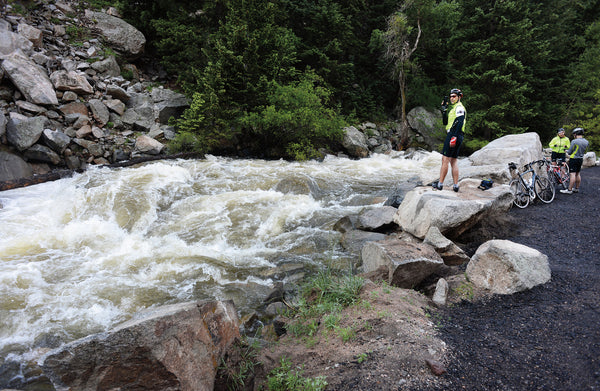 Cyclists check out a fast-moving Boulder Creek as they take a break on their way up Boulder Canyon in 2014.  Helen H. Richardson, The Denver Post