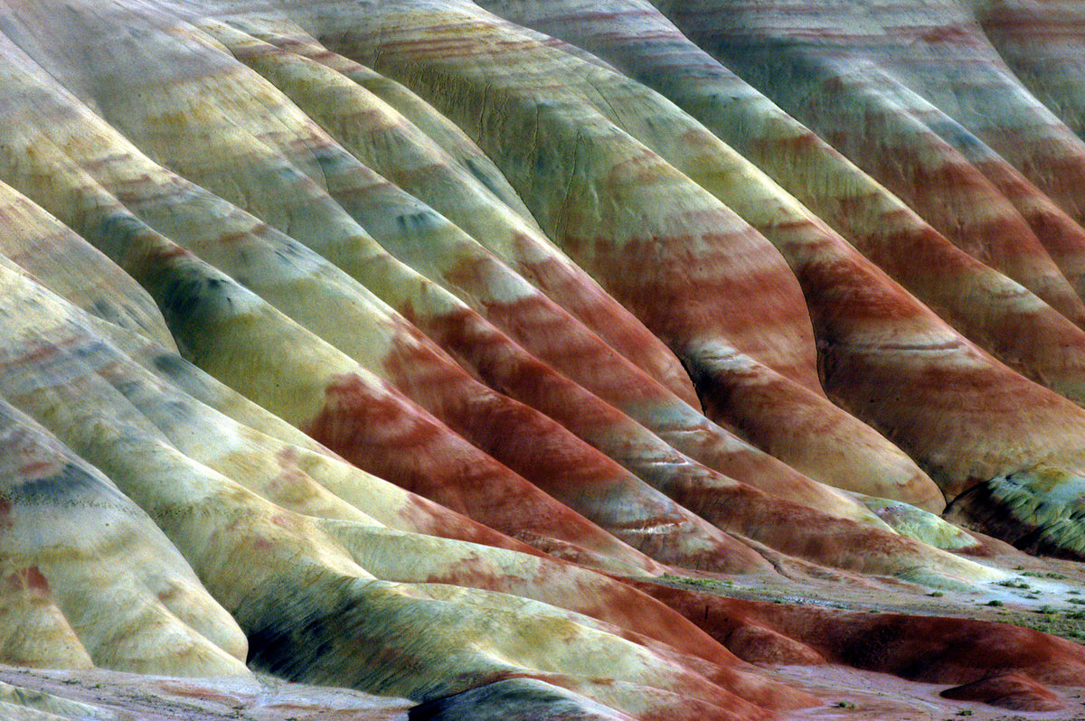 The Painted Hills unit of the John Day Fossil Beds National Monument are about an hour Northeast of Redmond and 8 miles NW of Mitchell. The Hills are formed from volcanic ash deposits banded with bright red, brown and yellow earth. Short trails provide viewing opportunities but the hills are off limits for walking.
