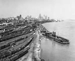 Wabash Railway’s railyard along the western riverfront, taken from the Ambassador Bridge, circa 1952. Wabash Railway’s car ferry Detroit of Detroit is docked on the right. In the background are the adjacent railyards of Chesapeake & Ohio Railway and New York Central System. The downtown skyline is visible further in the distance, where the City-County Building can be seen under construction.Courtesy Detroit Historical Society / #2009.019.253