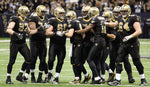 Drew Brees is surrounded by his team after breaking Dan Marino’s single-season passing record during a 2011 game against the Atlanta Falcons in the Superdome in New Orleans. Eliot Kamenitz / The Times-Picayune | The Advocate