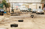 Cars make their way around debris on Raymond Boulevard in Newark. Jennifer Brown / The Star-Ledger