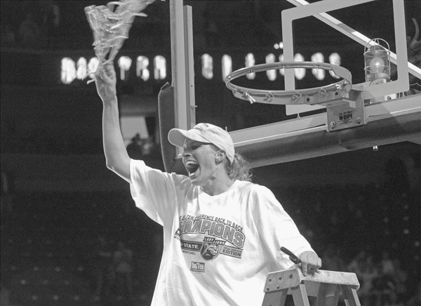 Penn State’s Kelly Mazzante makes the final cuts and waves the net after defeating Purdue for the Big 10 regular season championship, Feb. 29, 2004. Centre Daily Times Archives, Craig Houtz photo