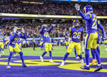 Los Angeles Rams defensive back David Long (22), right, celebrates with teammates after scoring a pick six against Arizona Cardinals quarterback Kyler Murray (1) in the NFC divisional playoff game at SoFi Stadium. Robert Gauthier/Los Angeles Times