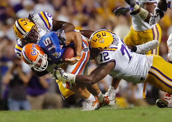 Tyson Jackson and Glenn Dorsey, right, sack Florida’s Tim Tebow on Oct. 6, 2007, in Tiger Stadium. Travis Spradling / The Advocate