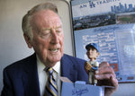 Vin Scully holds a Sandy Koufax bobblehead doll on the anniversary of Koufax’s perfect game, in which Scully’s call is as remembered as Koufax’s performance. LAWRENCE K. HO / LOS ANGELES TIMES
