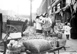A farmer displays his potatoes and cabbages at Eastern Market in the early twentieth century. Eastern Market opened at its current location in 1891. Courtesy The Detroit News