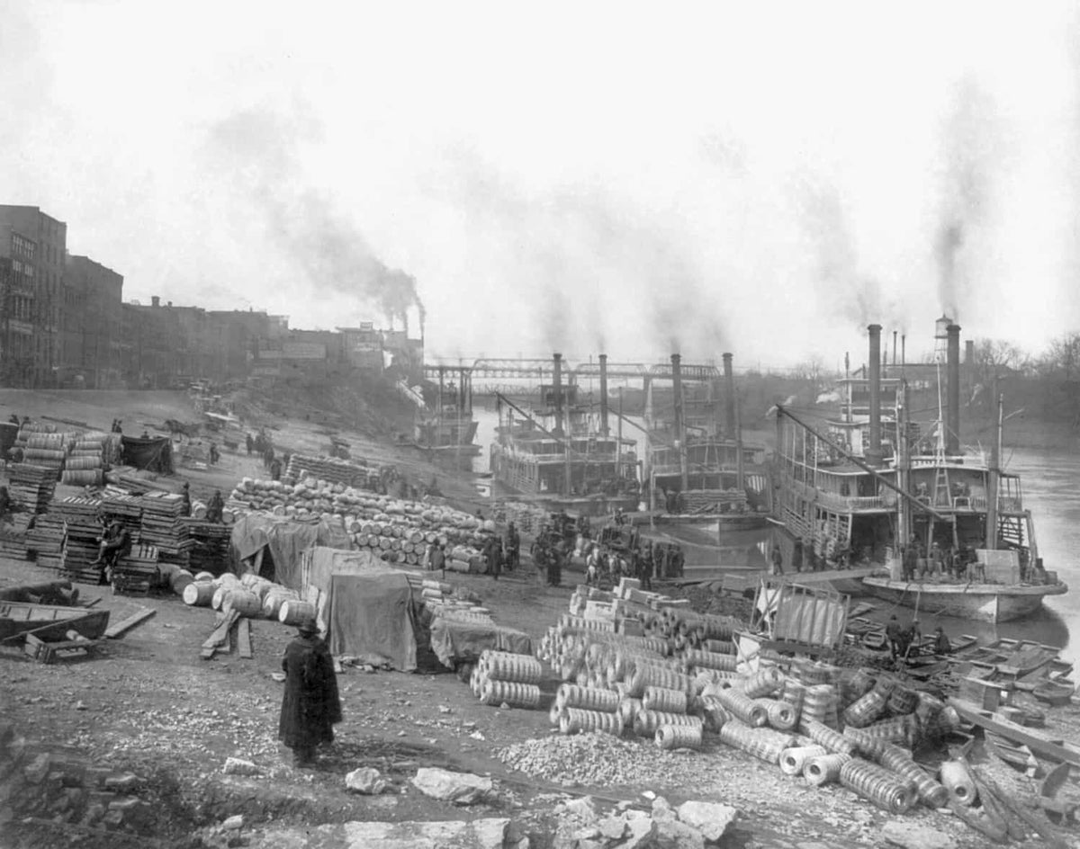 Four riverboats (sternwheelers) tied up at riverbank barrels, sacks, palettes, and rolls of wire, circa 1906. Courtesy Library of Congress