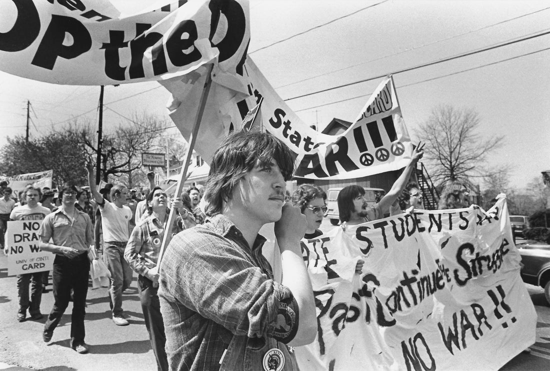 Marchers carry banners through the streets of Kent as they participated in the 10-year remembrance of the May 4, 1970 shootings. The marchers numbered somewhere over 500, and were made up of various politically motivated groups, May 4, 1980. Courtesy Akron Beacon Journal