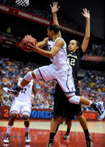 UConn’s Maya Moore looks for a passing lane as she leaps around Baylor’s Brittney Griner in the 2010 NCAA Final Four semifinals in San Antonio, Texas. Sean D. Elliot / The Day