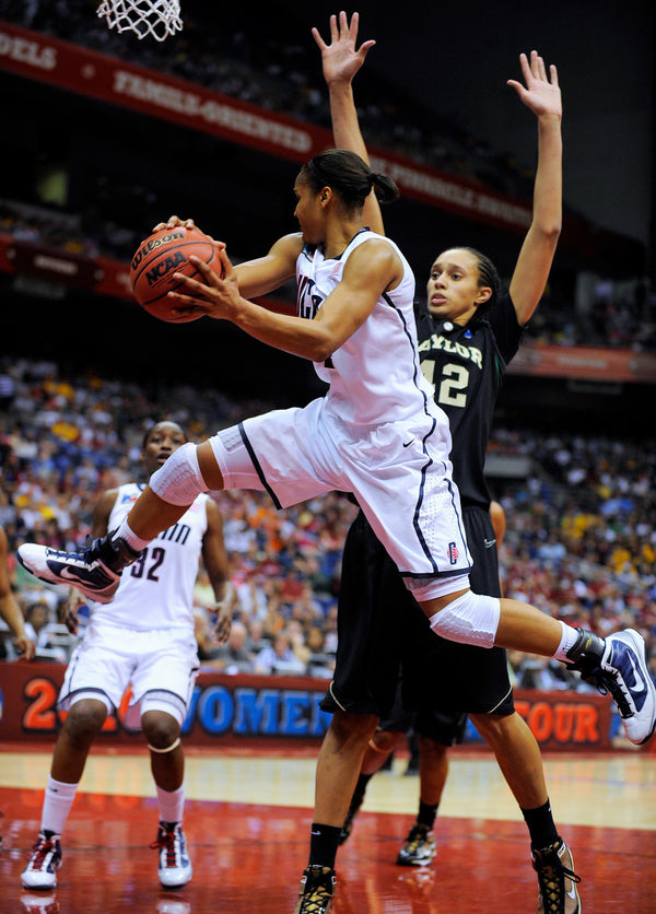 UConn’s Maya Moore looks for a passing lane as she leaps around Baylor’s Brittney Griner in the 2010 NCAA Final Four semifinals in San Antonio, Texas. Sean D. Elliot / The Day