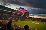 A fan flies an American flag with the Orlando City shield on it as the sun sets before the Lions’ game against the Impact. On this night, the sun would not set on Orlando City’s playoff hopes. Jacob Langston / Orlando Sentinel