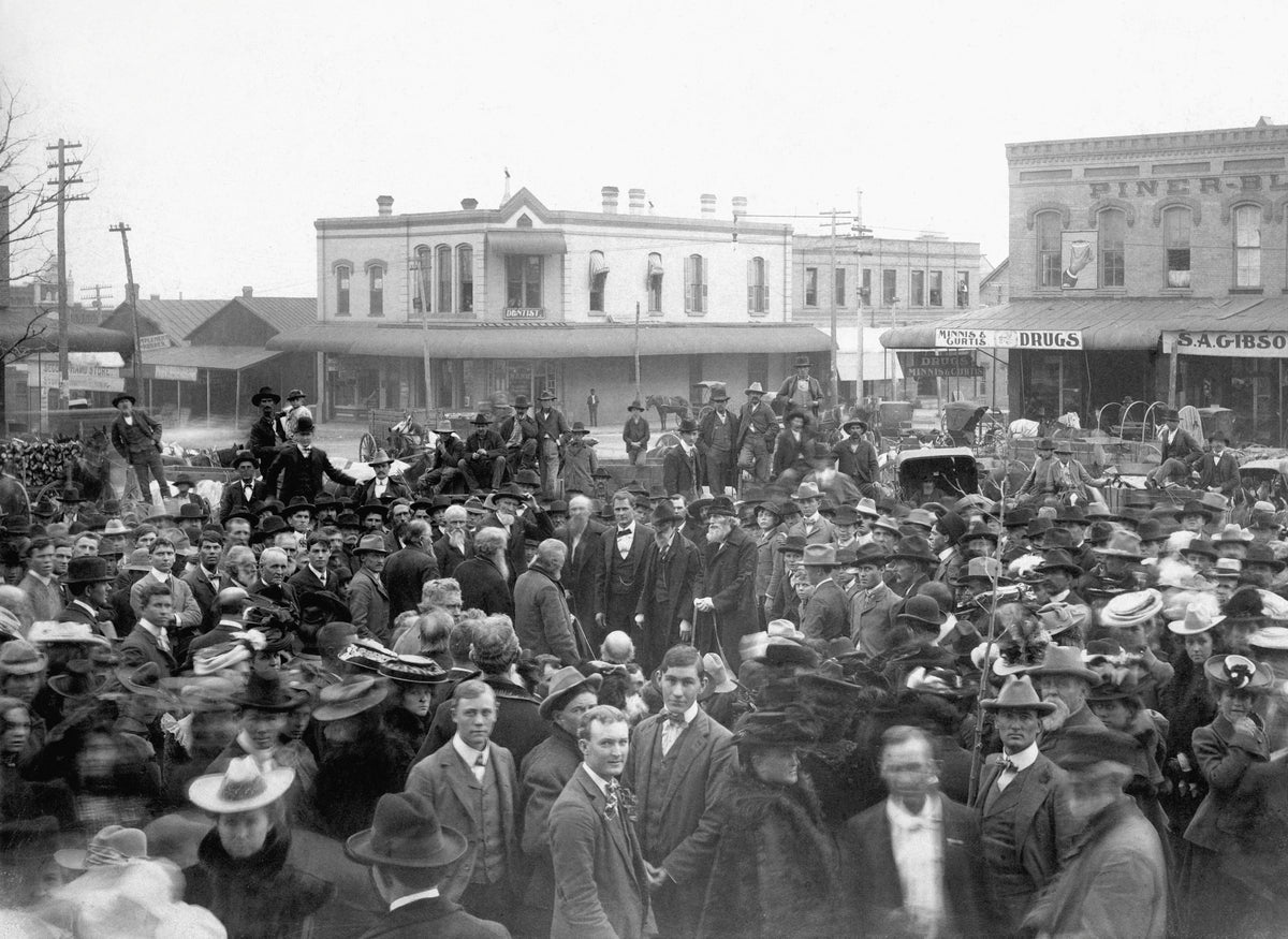 Group on Denton Square for the burial of John B. Denton on the lawn of the Denton County Courthouse, November 21, 1901. The pallbearers were E. B. Orr, L. Willis, J. M. Swisher, John W. Gober, J. H. Hawkins, and W. C. Wright. Visible are the The Minnis and Curtis Drugstore in the southeast corner of the square and the Exchange National Bank in the background. Courtesy Denton Public Library / #PF_C-5