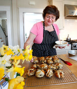 Clare Schapiro glazes hot cross buns in her kitchen Mon. March 19, 2012.