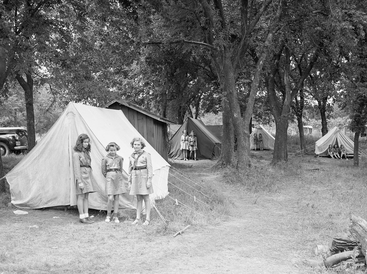 Tents were set up at Girl Scout Camp Keawa. Six canvas tents provided shelter for 15 girls. Many of the girls stayed an entire week during the summer camp. Standing next to their tent are: left to right, Mary Ellen Hinkle, Lucille Goodrich and Thelma Isley. 1942
