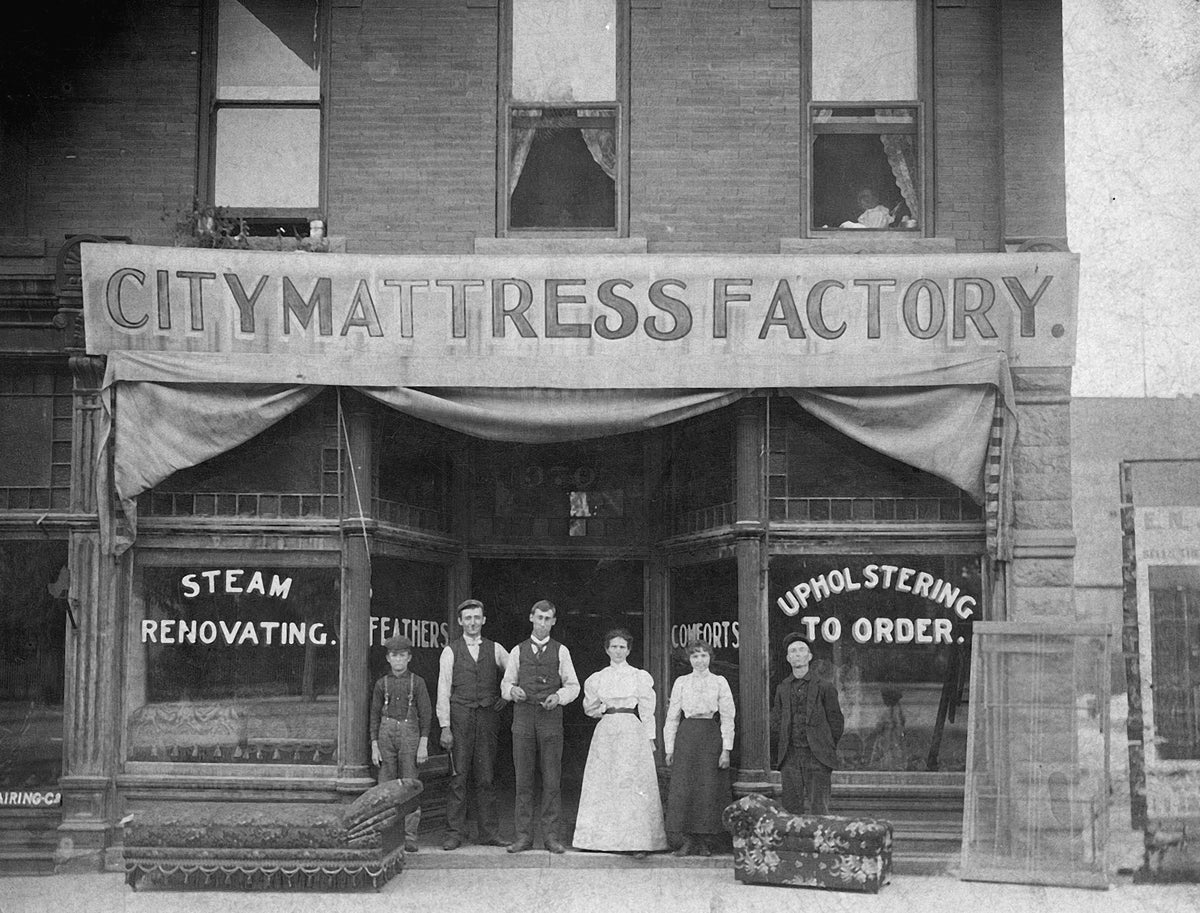 A photo of a family in front of City Mattress Factory, located at 400 S. Main St. in Salt Lake City, in 1898. The Salt Lake Tribune