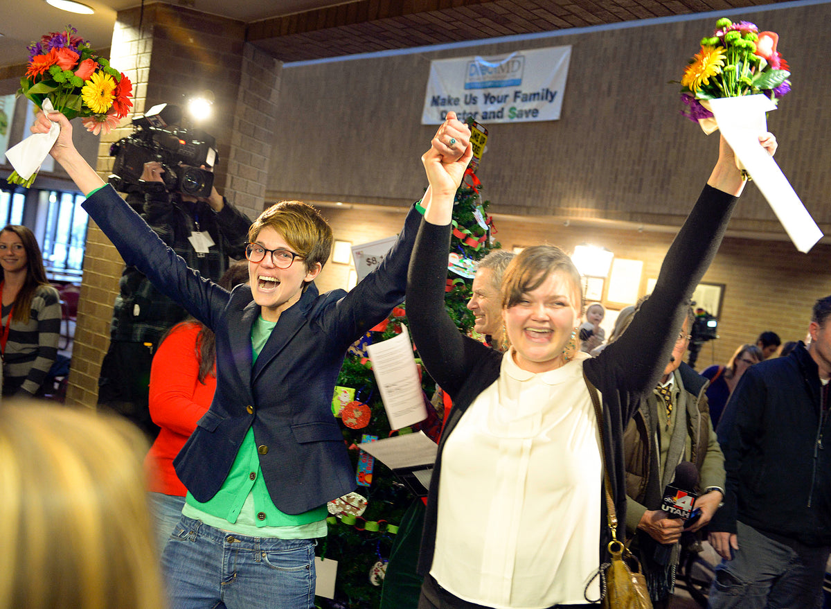 Natalie Dicou, left, and Nicole Christensen celebrate after being married by Salt Lake City Mayor Ralph Becker in December 2013. A federal judge in Utah struck down the state’s ban on same-sex marriage and couples flocked to the county complex to get married. The Supreme Court would legalize gay marriage nationwide in 2015. Keith Johnson / The Salt Lake Tribune
