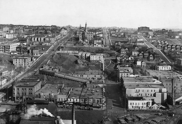 A view from Second Avenue South near South Jackson Street looking east, circa 1900. The building with the steeple was Holy Names Academy, which in a few years would move to its current location on Capitol Hill. Courtesy Seattle Public Library