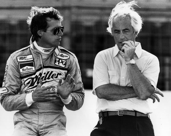 Danny Sullivan (left) and Roger Penske talk speed on the pit wall during an extended yellow caution. John Gentry/The News 1987